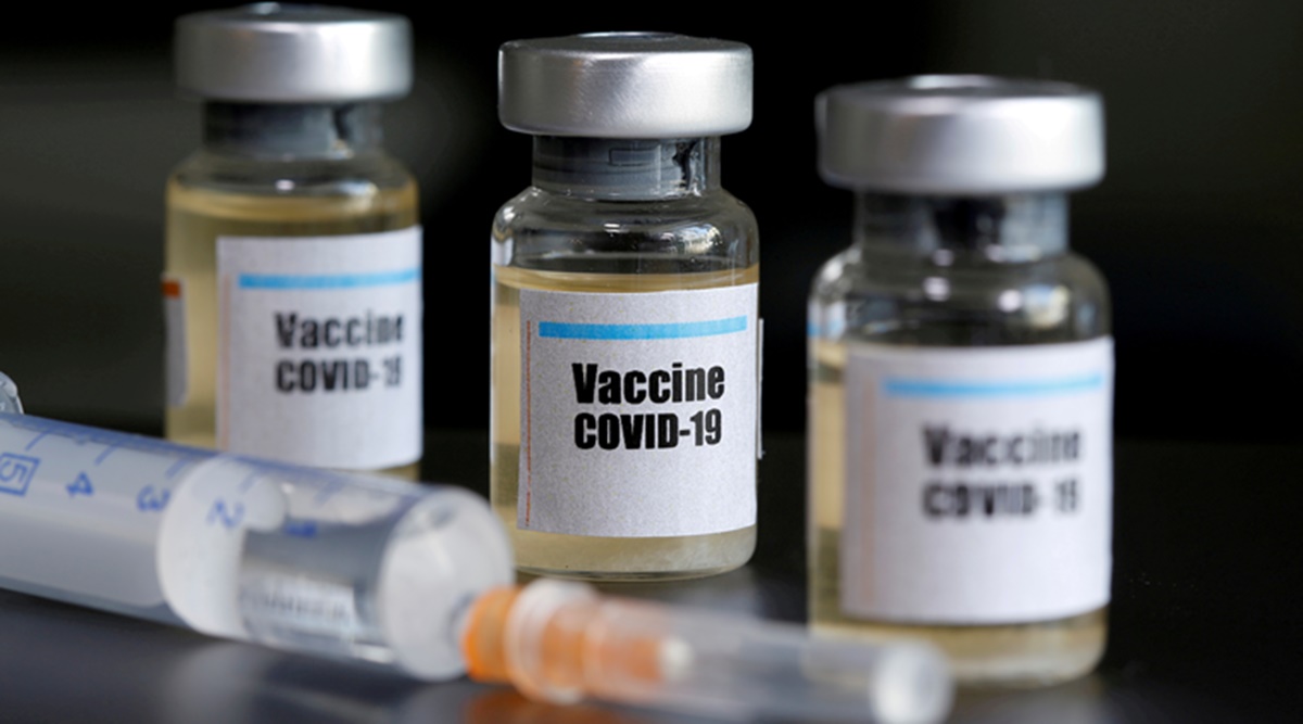 FILE PHOTO: Small bottles labeled with a "Vaccine COVID-19" sticker and a medical syringe are seen in this illustration