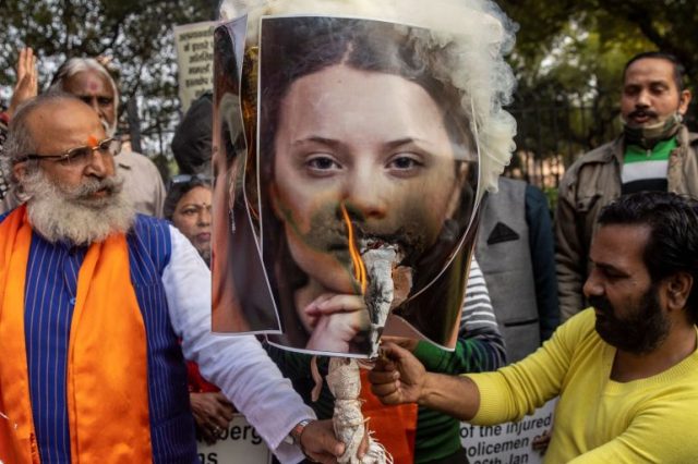 Activists from United Hindu Front burn an effigy depicting climate change activist Greta Thunberg to protest against the celebrities for commenting in support of protesting farmers, in New Delhi
